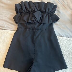 Black strapless romper with ruffle